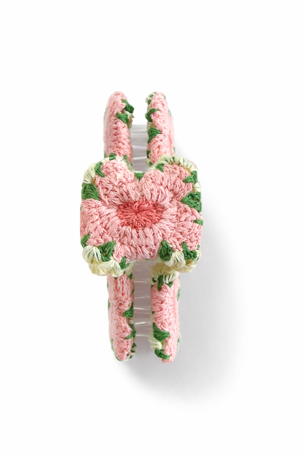Pink and green handmade crochet hair clip on white background The Pixie Garden