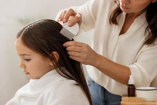 Parent wet combing child's hair for non-toxic lice treatment using conditioner and a metal nit comb The Pixie Garden