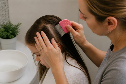 Cosmetologist wet-combing a child's damp hair with a fine metal nit comb for natural lice removal The Pixie Garden