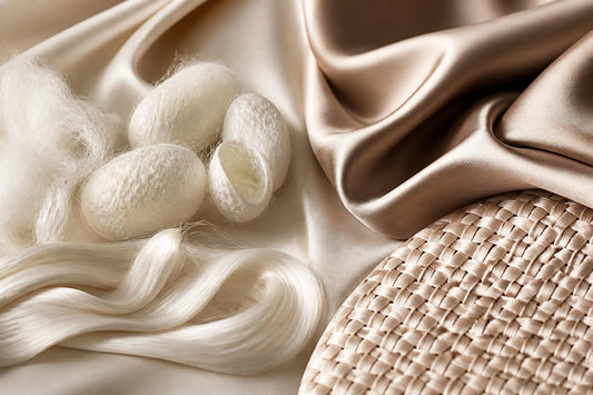Mulberry silk scrunchie beside a polyester satin pillowcase in a silk vs satin for hair comparison at The Pixie Garden