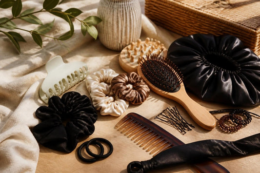 Curated hair gift set with silk scrunchies, claw clips, and a finishing stick arranged on a vanity, The Pixie Garden