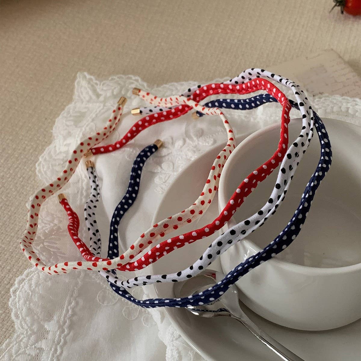 Beige polka dot wavy thin headband, worn view, The Pixie Garden