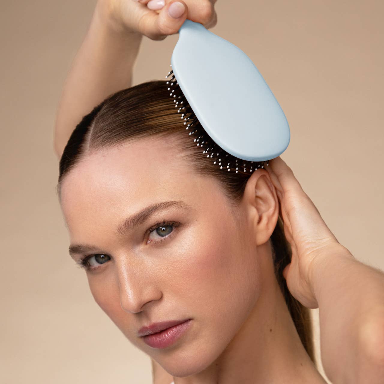 Woman using Kitsch Smooth and Polish hair brush scalp stimulation salon technique