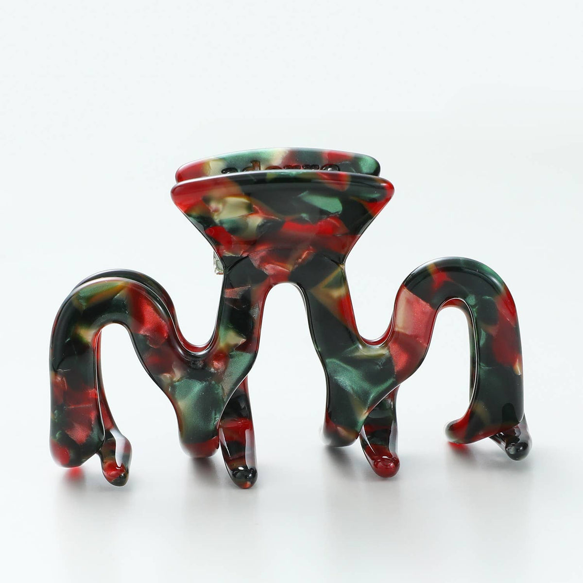 Small octopus-style Vintage Christmas claw clip standing on its teeth