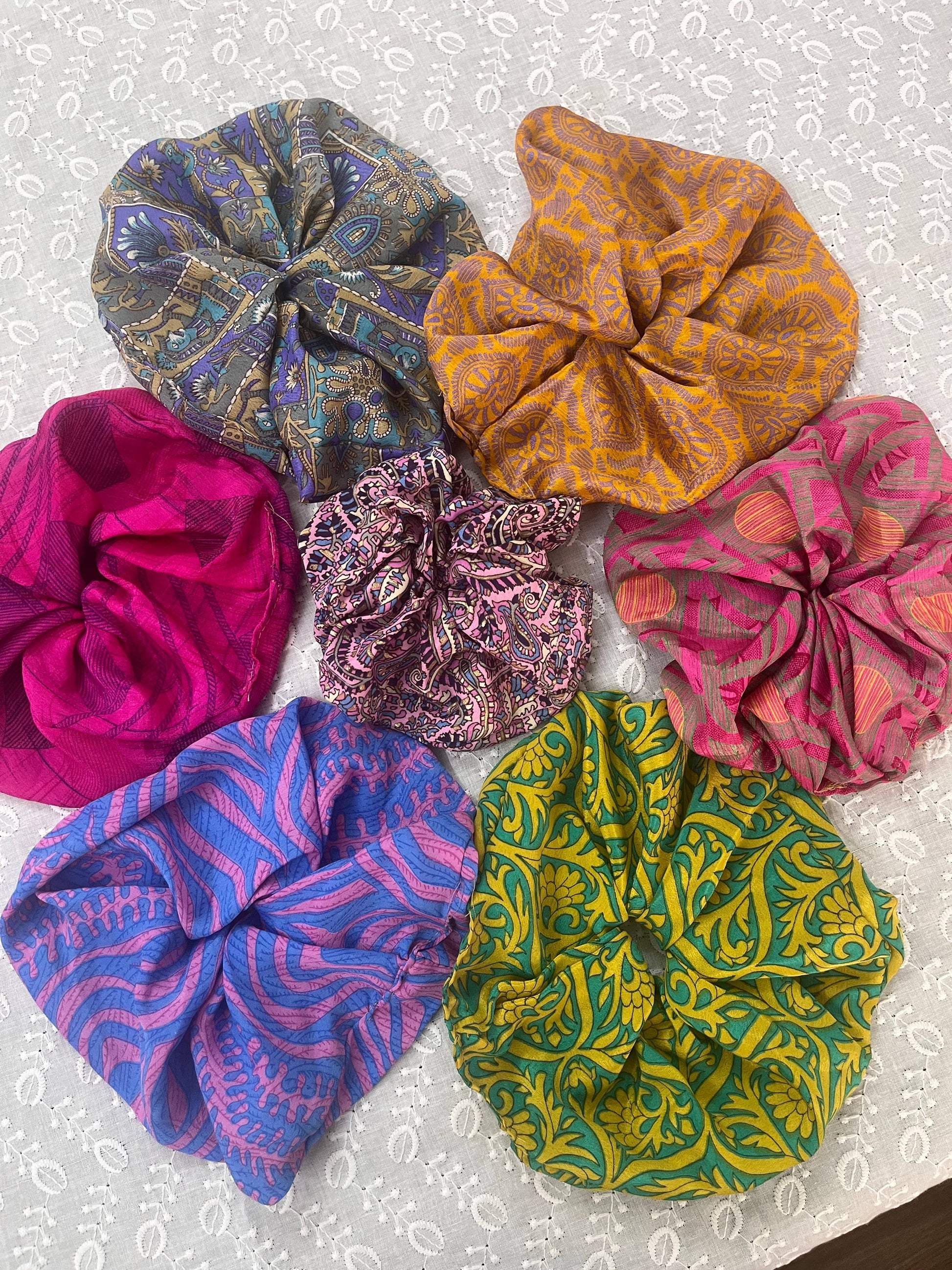 Upcycled boho silk scrunchie worn on the wrist, salon-selected