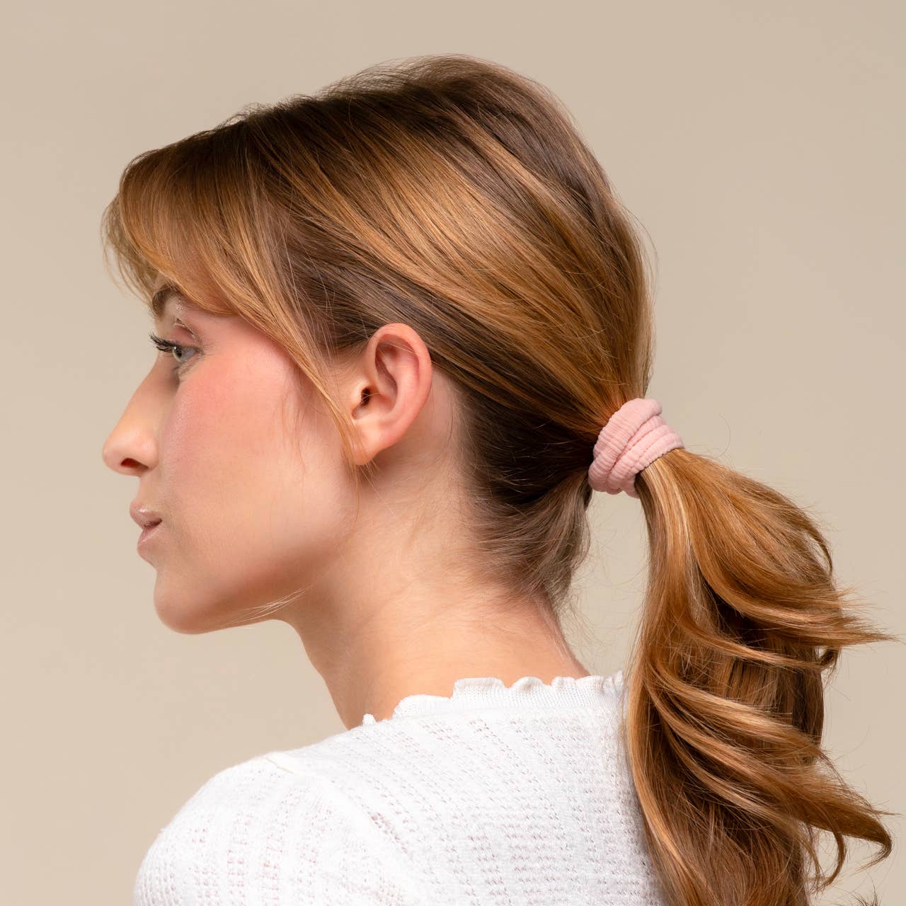 Woman with ponytail wearing recycled fabric ribbed hair elastic salon-selected
