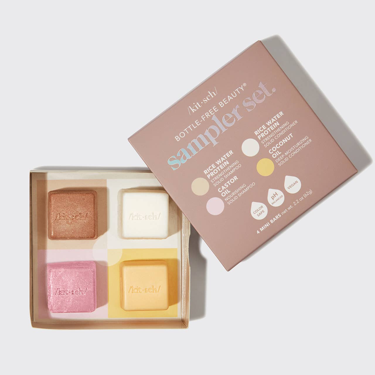 4 bottle-free beauty sampler set with four soap bars in a box on a white background