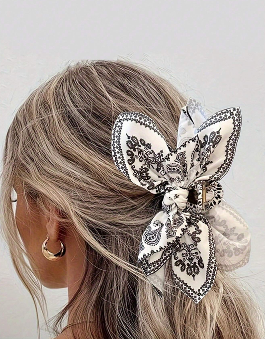 Black and white paisley bow hair clip worn in half-up style lifestyle shot