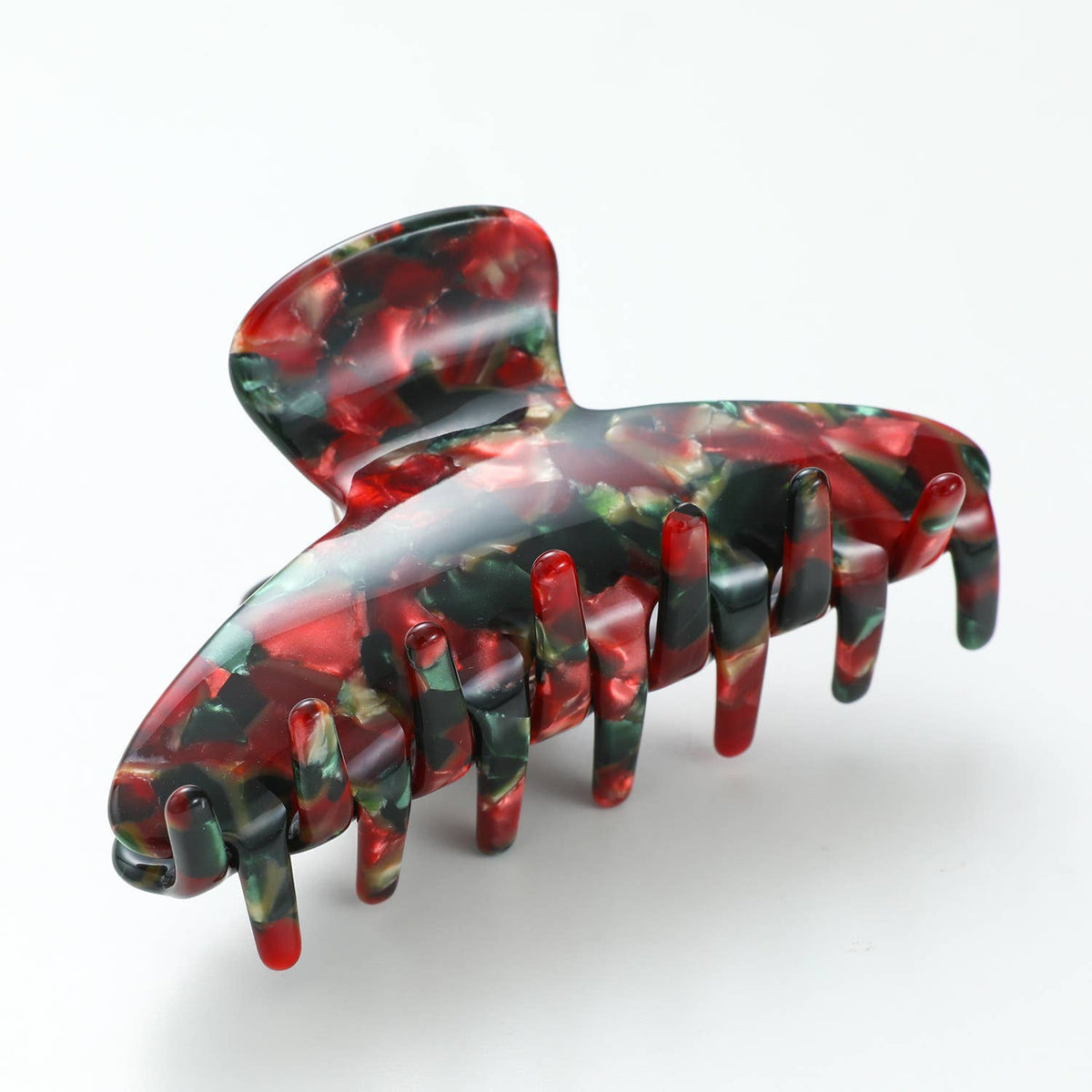 Side view of the curved Vintage Christmas claw clip in marbled red, green and gold cellulose acetate