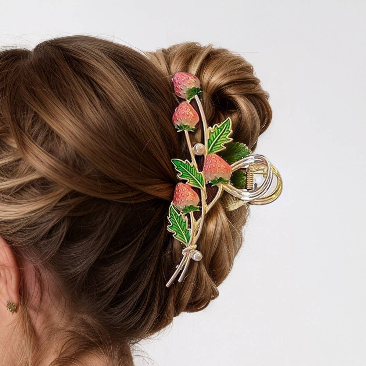 Cute red strawberry claw clip holding a hair twist, The Pixie Garden