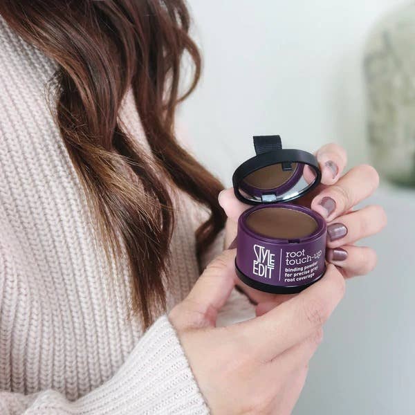 Hands holding an open Style Edit brunette root touch-up compact