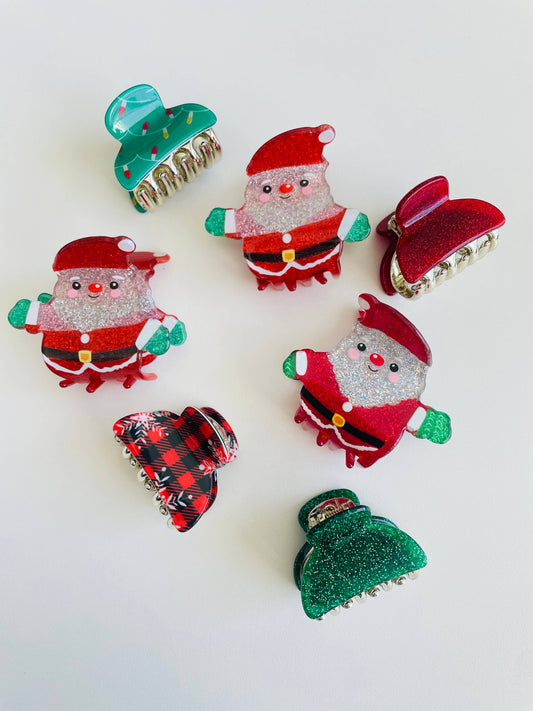 Mini Christmas claw clips shown together, covering the Santa, Flannel, Christmas Tree Lights, Red Sparkle and Green Sparkle designs