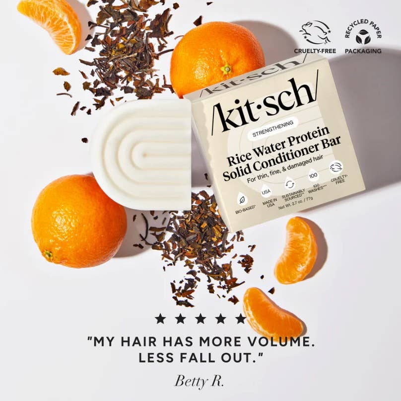Kit'sch Rice Water Protein Solid Conditioner Bar with oranges and tea leaves on a light background