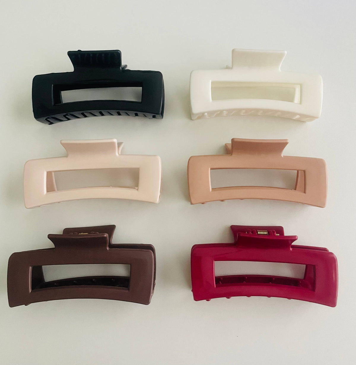 Silicone bendable rectangle claw clips shown in the full color range, including brown, white and red