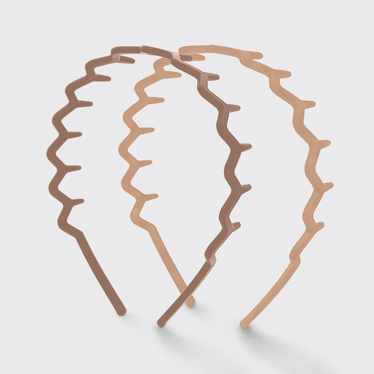 Two neutral zig zag headbands in tan and light taupe showing the wavy comb teeth
