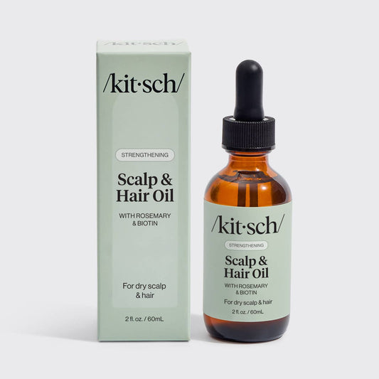 KITSCH Strengthening Scalp and Hair Oil amber dropper bottle beside its green box, The Pixie Garden
