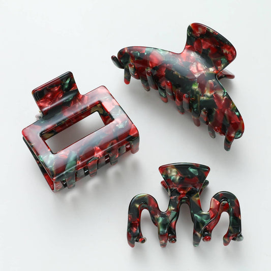 Three Vintage Christmas claw clip shapes together, rectangle, curved and small octopus, in marbled red green and gold acetate