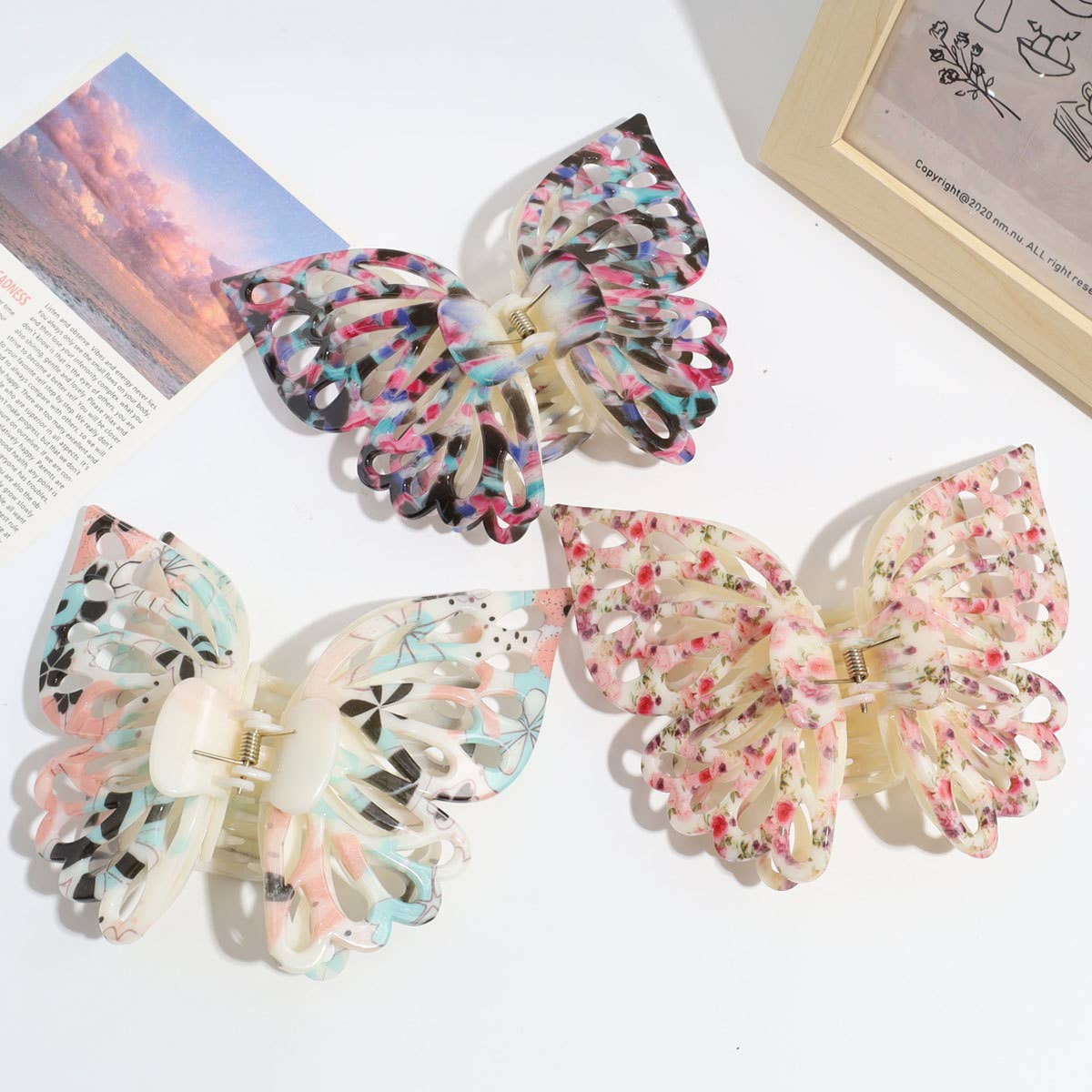 Large pink gradient butterfly claw clip holding an updo, The Pixie Garden
