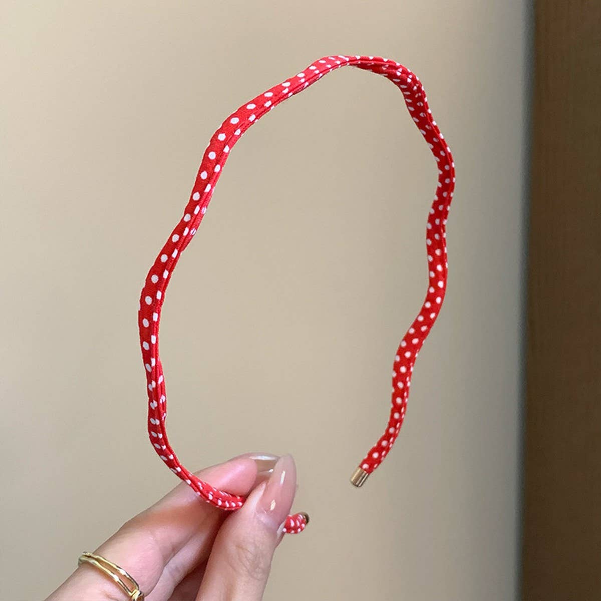 Beige polka dot wavy thin headband, packaging view, The Pixie Garden