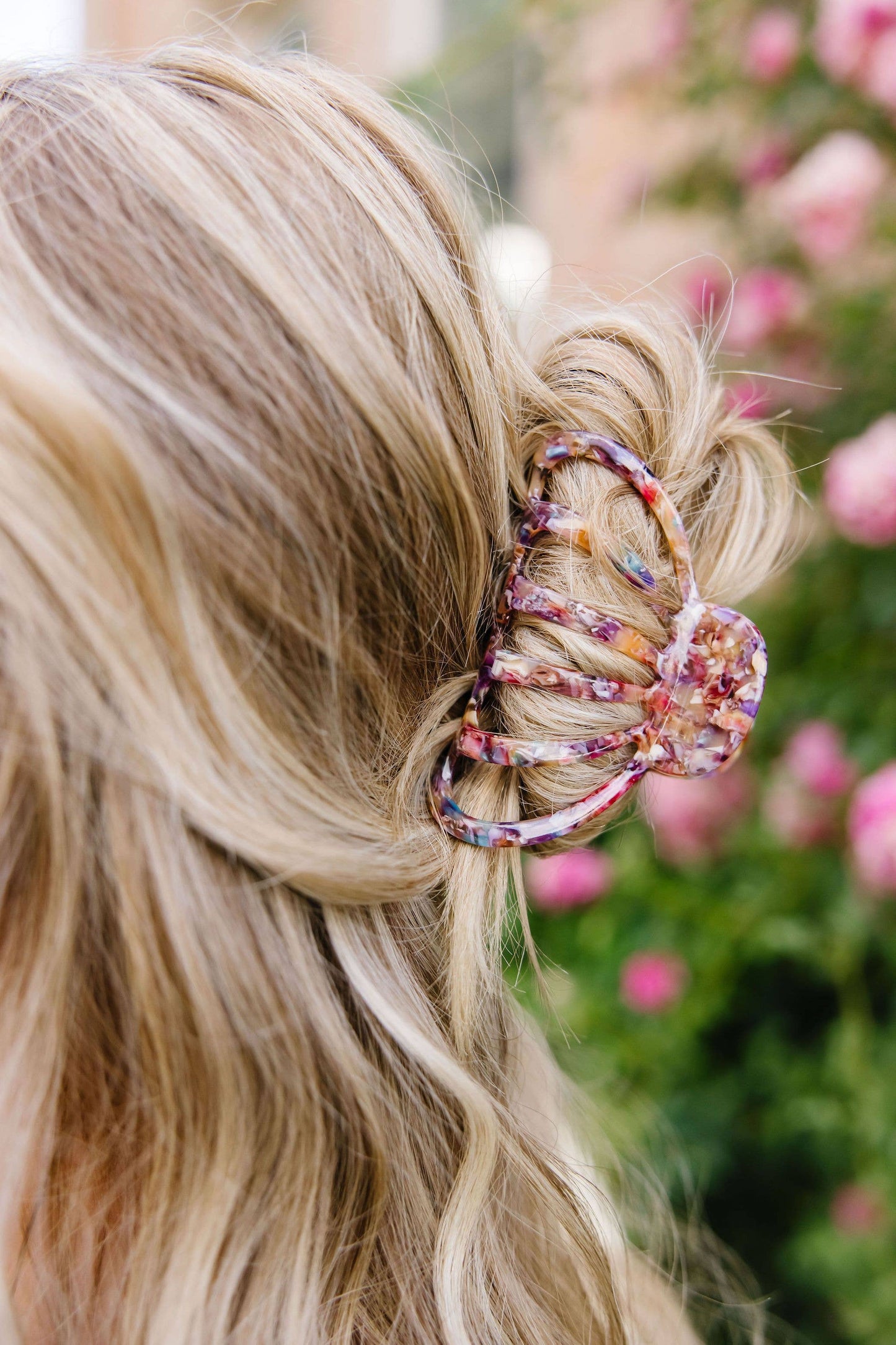 Carlisle claw clip worn in hair close-up floral background salon-selected The Pixie Garden