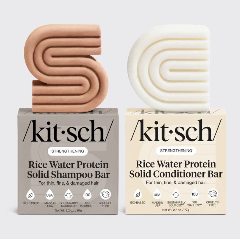 Two 'kitsch' rice water protein solid shampoo and conditioner bars on a light gray background.