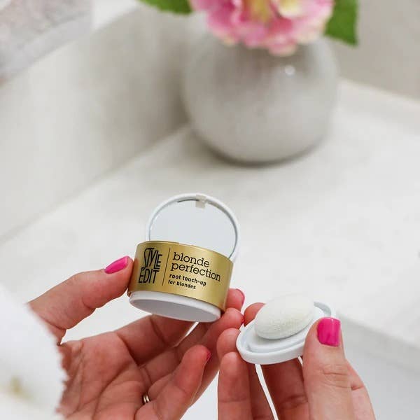 Hands opening a Blonde Perfection root touch-up compact